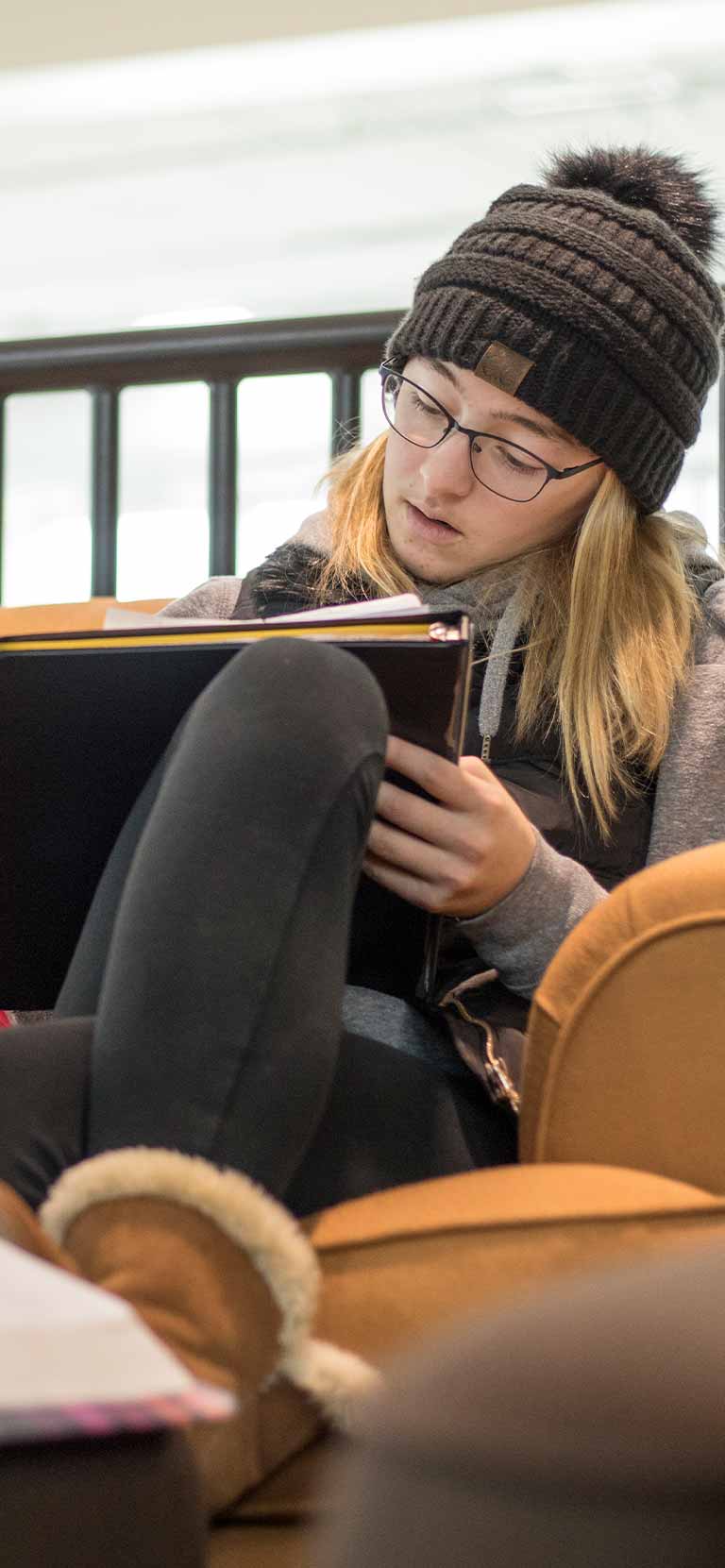 Student working on a notebook in the student center