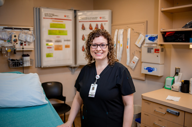 Nurse standing in front of hospital bed