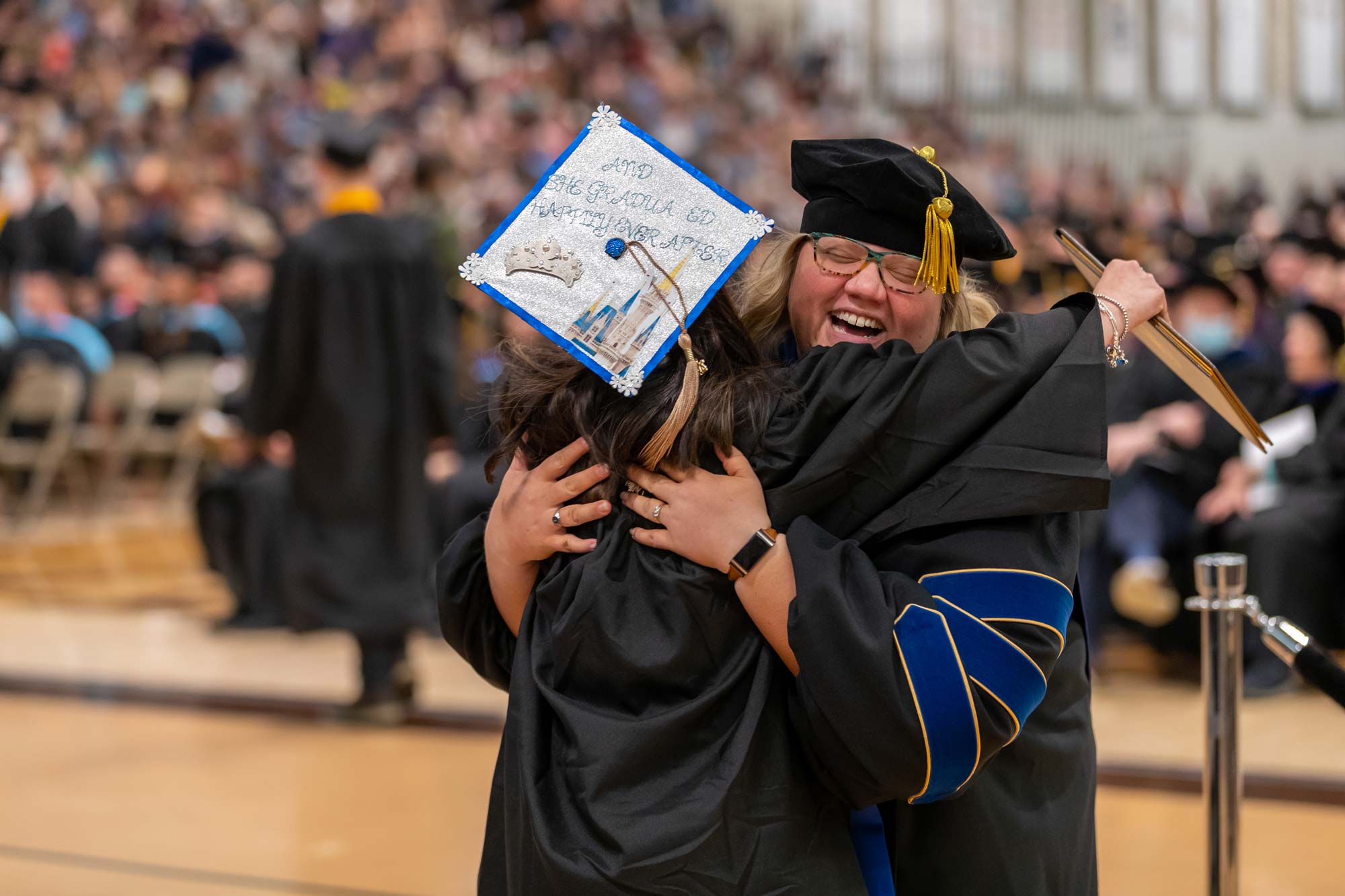 Dr. Heather Rickgarn, right, congratulates a student at commencement. She is one of the faculty members teaching in the Accelerated MBA Programs