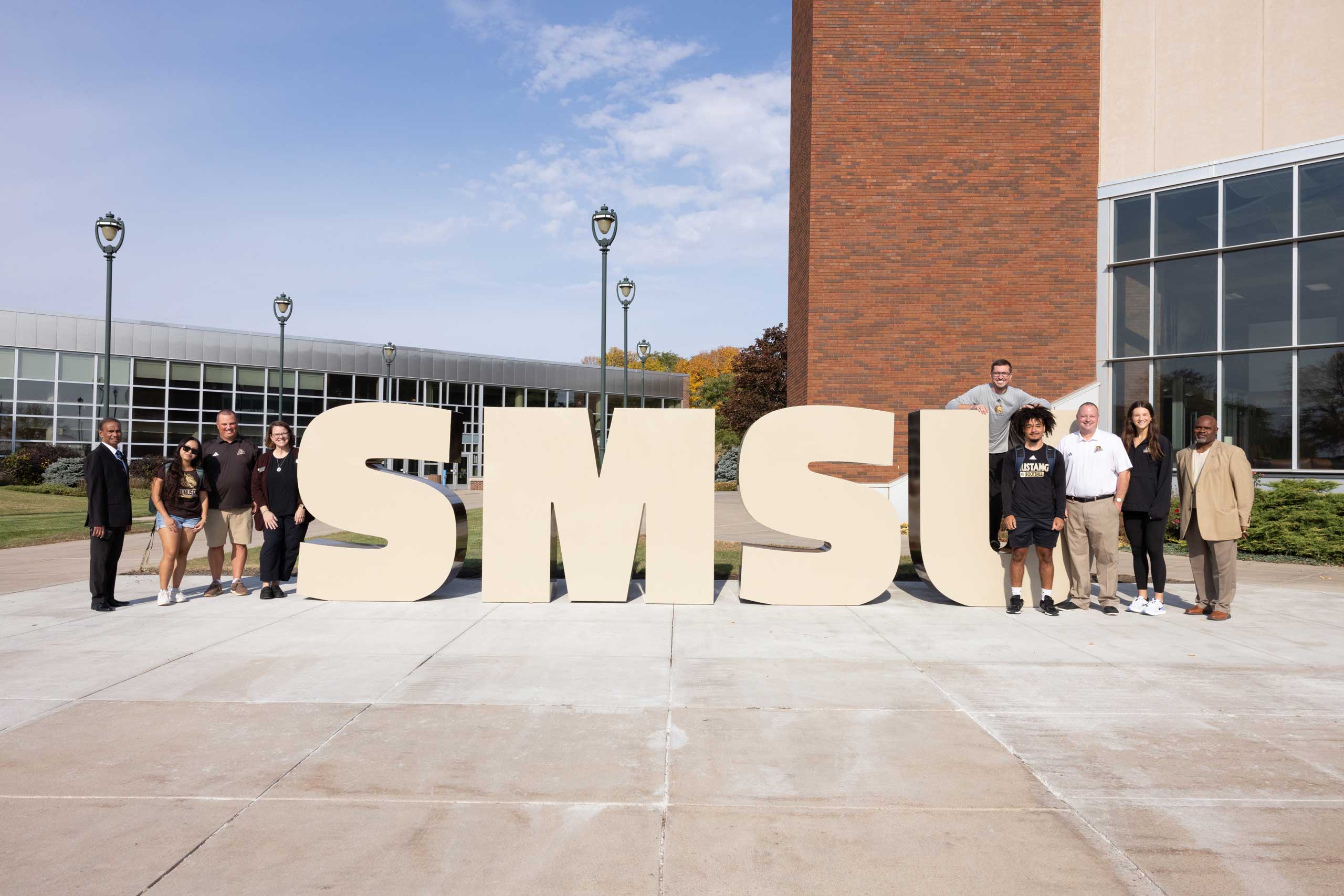 Members of the campus community gather at the Welcome Walkway